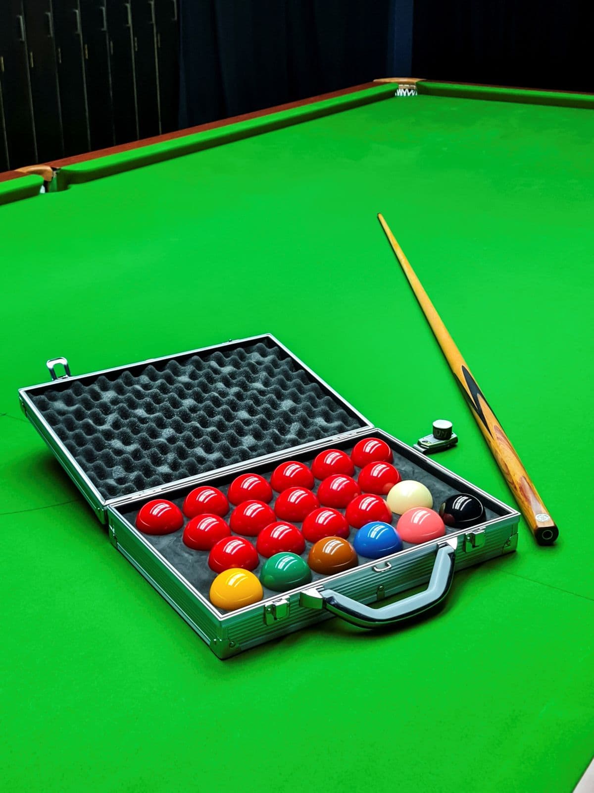 Tournament ball case on green baize